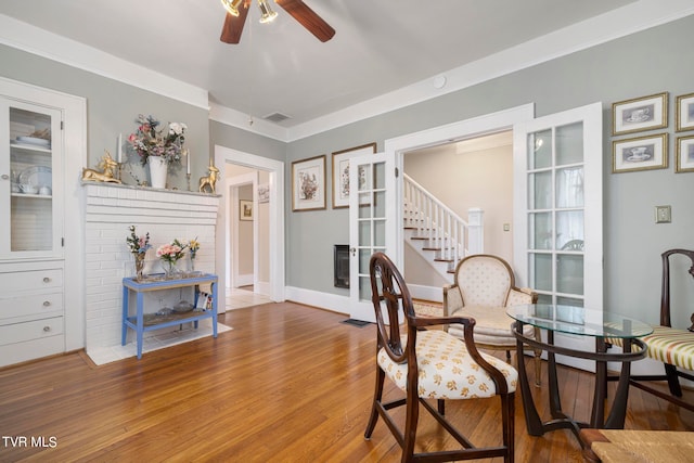 dining room with ornamental molding, ceiling fan, and wood-type flooring