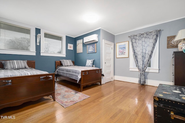 bedroom featuring light wood-type flooring and a wall mounted air conditioner