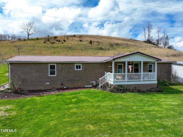 ranch-style house with covered porch and a front lawn