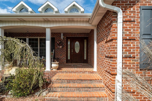 entrance to property featuring covered porch