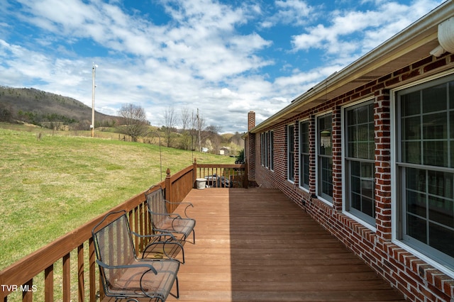 wooden terrace featuring a yard