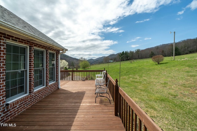 deck featuring a yard and a mountain view