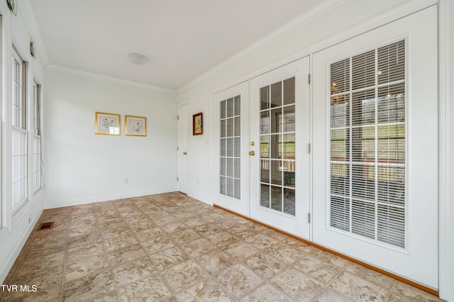 unfurnished room with ornamental molding, light tile floors, and french doors