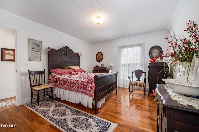 bedroom featuring a textured ceiling, ornamental molding, and light hardwood / wood-style floors