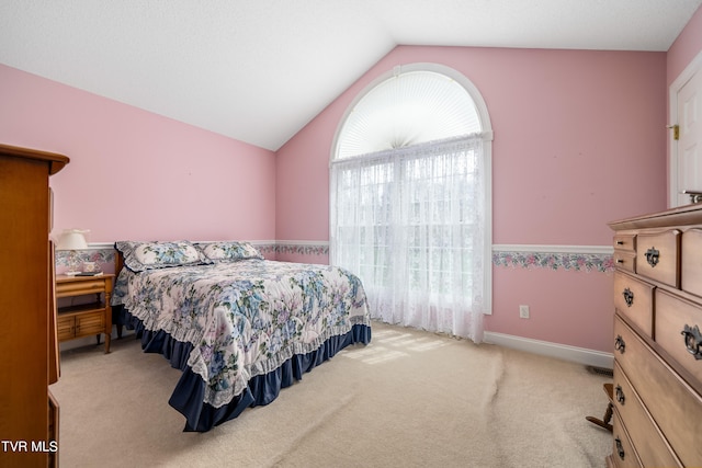 bedroom featuring lofted ceiling and light colored carpet