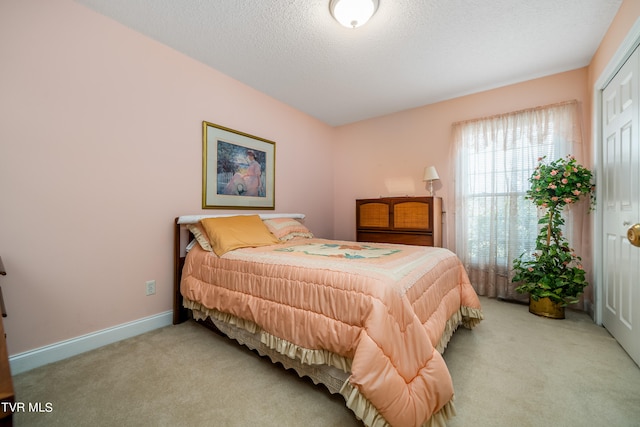 carpeted bedroom with a textured ceiling