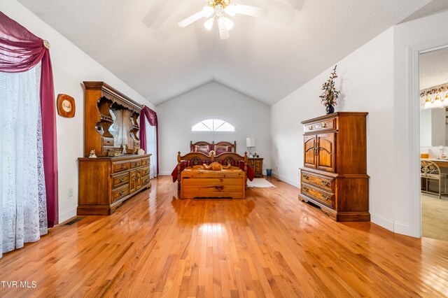 bedroom featuring ceiling fan, light wood-type flooring, and vaulted ceiling