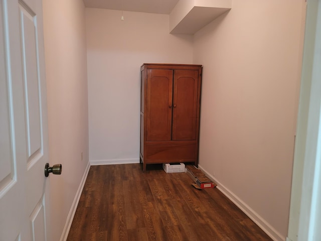 corridor featuring dark hardwood / wood-style floors