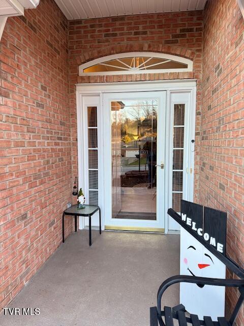 property entrance with brick siding