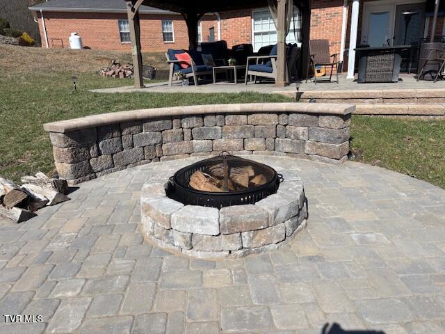 exterior details with an outdoor fire pit and heating fuel