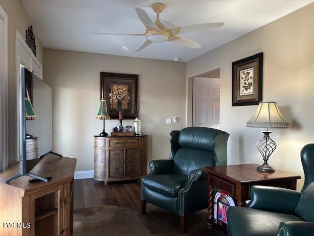 sitting room featuring baseboards, ceiling fan, and wood finished floors