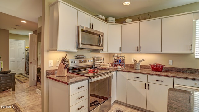 kitchen featuring white cabinetry, dark stone counters, recessed lighting, and stainless steel appliances