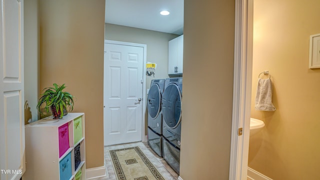 laundry area with washer and clothes dryer, cabinet space, and recessed lighting