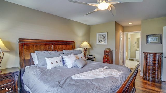 bedroom with dark wood-style flooring, connected bathroom, and ceiling fan