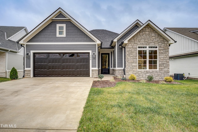 craftsman-style home with a garage, central AC unit, and a front yard