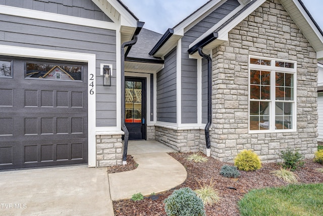 doorway to property with a garage