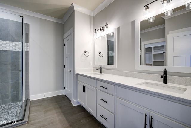 bathroom featuring crown molding, vanity, and a shower with shower door