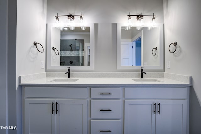 bathroom with vanity and a shower with door