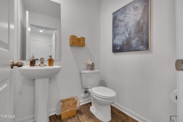 bathroom featuring toilet and hardwood / wood-style floors