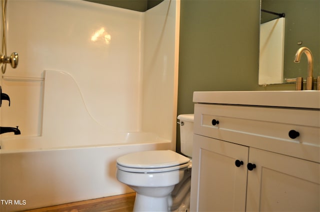 full bathroom with hardwood / wood-style floors, toilet, vanity, and shower / tub combination