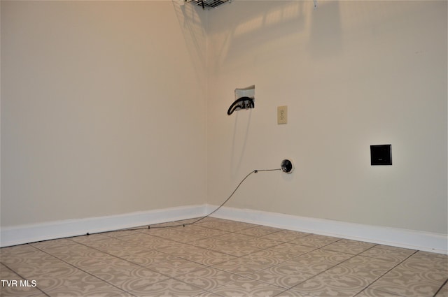 clothes washing area featuring tile floors