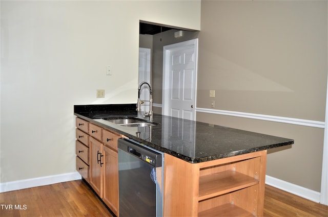 kitchen featuring sink, dark stone counters, hardwood / wood-style flooring, and dishwasher