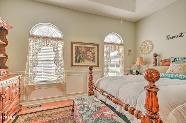 110 Eagle View Private Dr Unit 110, Blountville, TN 37617 - bedroom with wood finished floors, a wainscoted wall, multiple windows, and a decorative wall