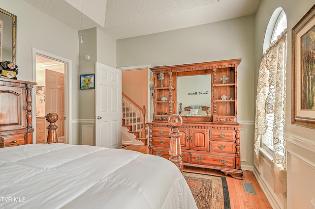 110 Eagle View Private Dr Unit 110, Blountville, TN 37617 - bedroom with wood finished floors, a wainscoted wall, and a textured ceiling