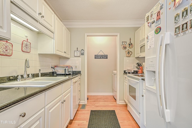110 Eagle View Private Dr Unit 110, Blountville, TN 37617 - kitchen featuring white appliances, dark countertops, decorative backsplash, light wood-style flooring, and white cabinetry