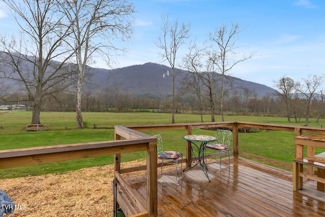 deck featuring a yard and a mountain view