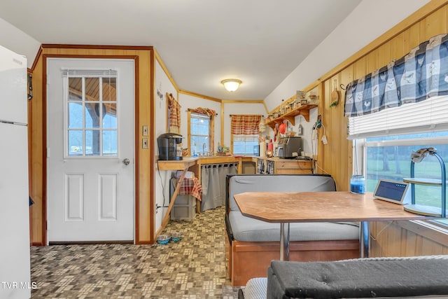 kitchen with tile flooring, dishwasher, and white refrigerator