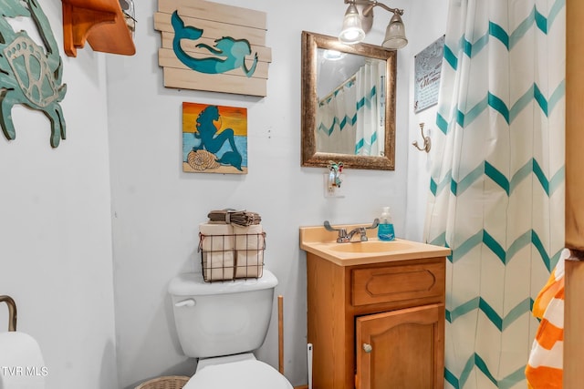 bathroom featuring oversized vanity and toilet