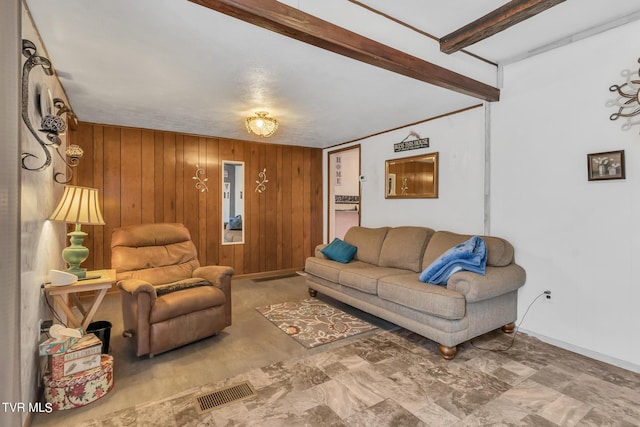 living room featuring tile floors, wooden walls, and beam ceiling