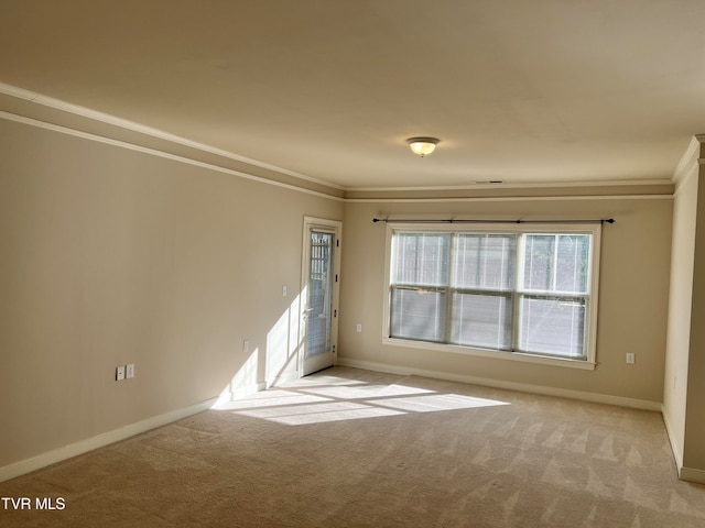 carpeted spare room with ornamental molding