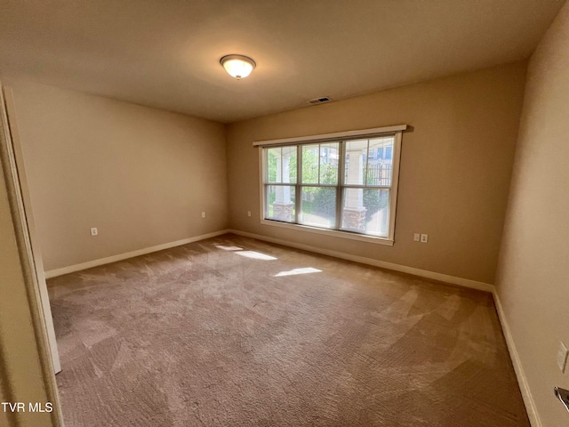 unfurnished room with light colored carpet