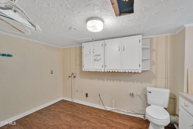 bathroom with a textured ceiling, hardwood / wood-style floors, toilet, ornamental molding, and vanity