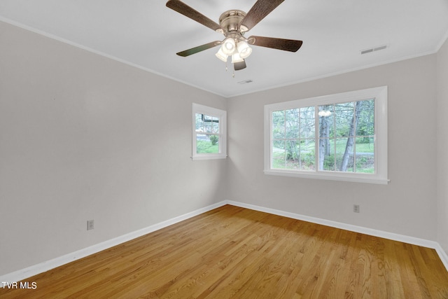 empty room featuring crown molding, light hardwood / wood-style floors, and ceiling fan