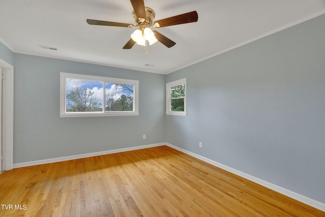 empty room featuring crown molding, light hardwood / wood-style flooring, and ceiling fan