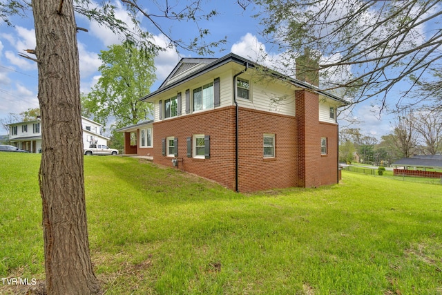 view of home's exterior with a yard