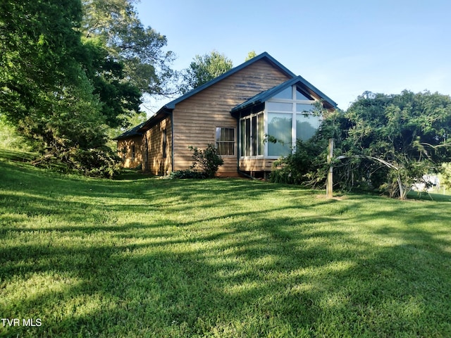 view of property exterior with a lawn