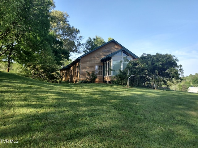 view of side of property featuring a yard