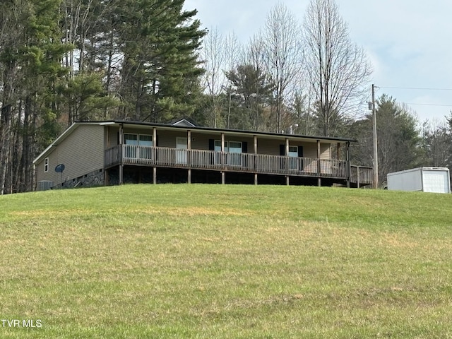 exterior space featuring a front lawn and a deck