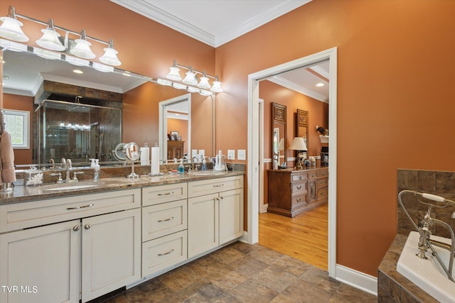 bathroom featuring hardwood / wood-style flooring, crown molding, vanity with extensive cabinet space, and double sink