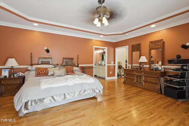 bedroom with ceiling fan, a raised ceiling, and light wood-type flooring