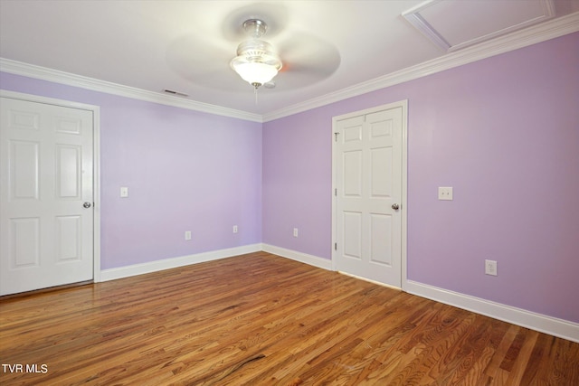 spare room with dark hardwood / wood-style floors, ceiling fan, and ornamental molding