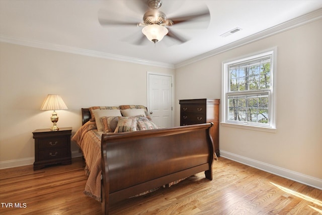 bedroom with ornamental molding, ceiling fan, and light wood-type flooring