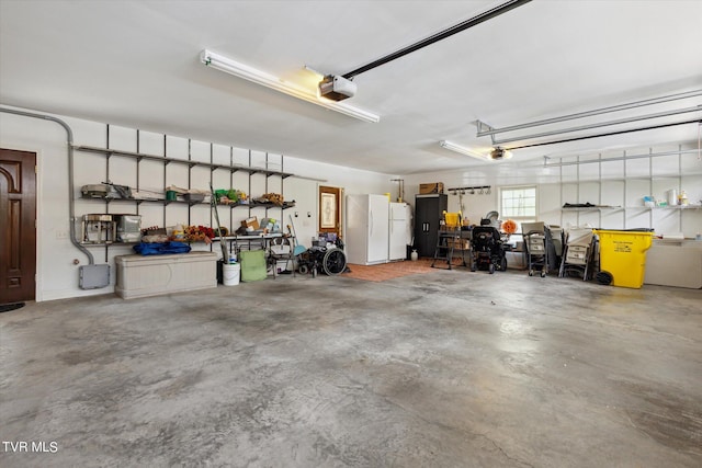 garage featuring white fridge and a garage door opener