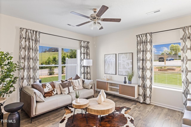 living room with wood-type flooring and ceiling fan