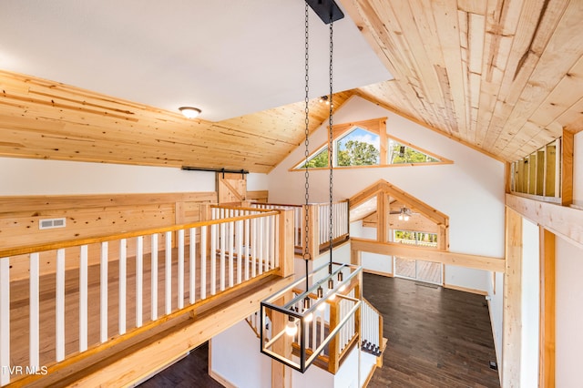 hallway with wooden ceiling, hardwood / wood-style flooring, and lofted ceiling