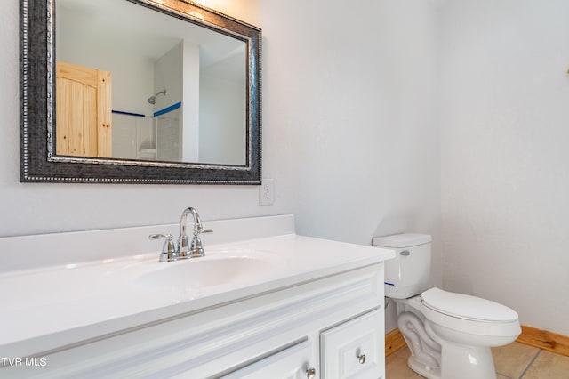 bathroom with tile patterned floors, vanity, and toilet